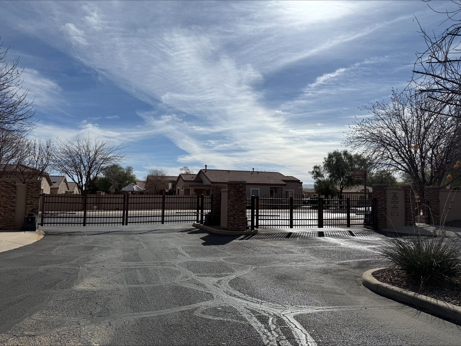 Gated residential community entrance with custom picket gate and stone pillars — Signal Gates